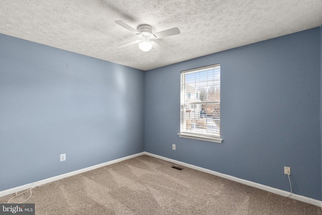 carpeted empty room with a textured ceiling and ceiling fan