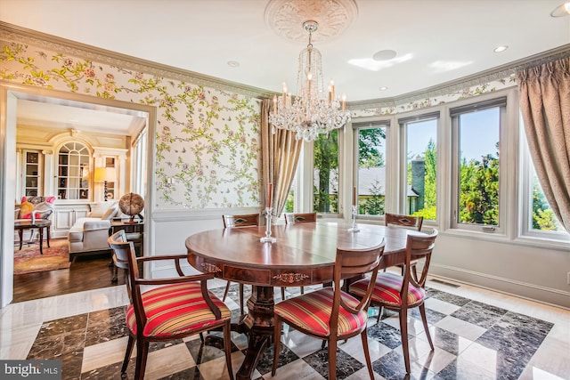 dining area featuring ornamental molding and a notable chandelier