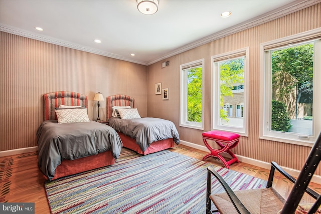 bedroom with hardwood / wood-style floors and ornamental molding