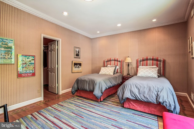 bedroom with hardwood / wood-style flooring and crown molding