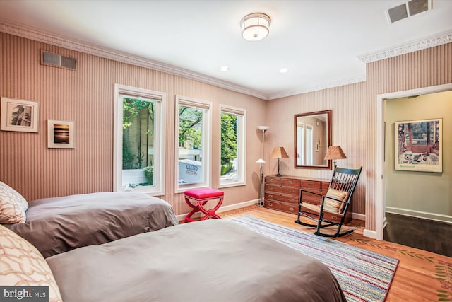 bedroom with light hardwood / wood-style flooring and crown molding