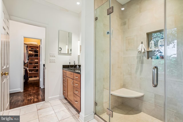 bathroom featuring tile patterned floors, vanity, and walk in shower