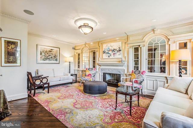 living room featuring crown molding, a high end fireplace, and dark wood-type flooring