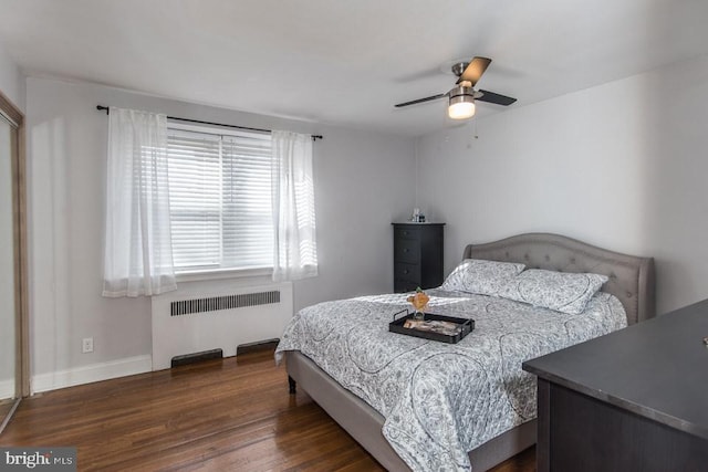 bedroom with dark wood-type flooring, radiator heating unit, and ceiling fan