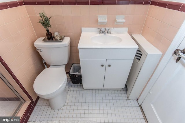 bathroom with vanity, toilet, and tile patterned flooring