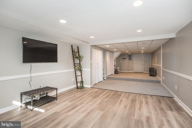 interior space with a drop ceiling and light wood-type flooring