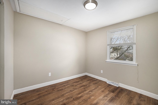 spare room with dark hardwood / wood-style flooring