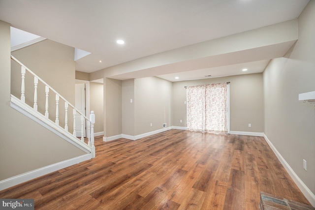 basement with hardwood / wood-style floors