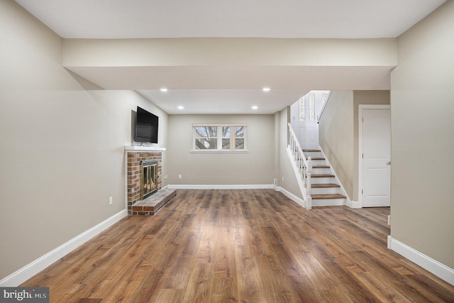 unfurnished living room with a brick fireplace and dark wood-type flooring