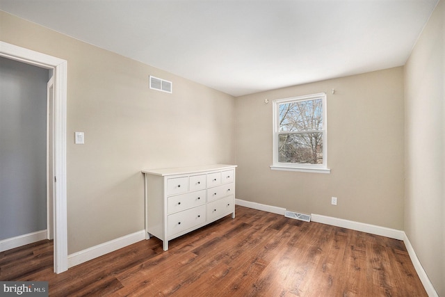 unfurnished bedroom featuring dark hardwood / wood-style flooring