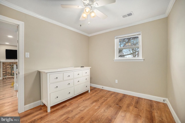 unfurnished bedroom with light hardwood / wood-style flooring, ornamental molding, and ceiling fan