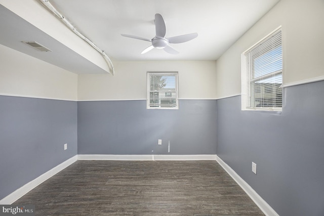 empty room featuring ceiling fan and dark hardwood / wood-style flooring