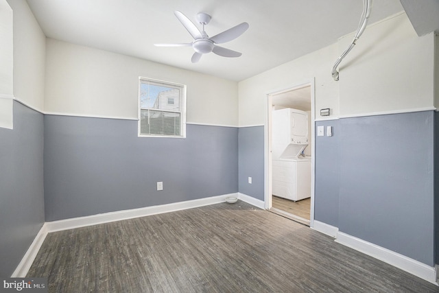 empty room featuring stacked washer and dryer, dark hardwood / wood-style floors, and ceiling fan