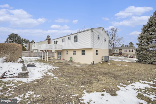 snow covered property featuring central air condition unit