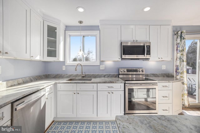 kitchen featuring appliances with stainless steel finishes, sink, and white cabinets