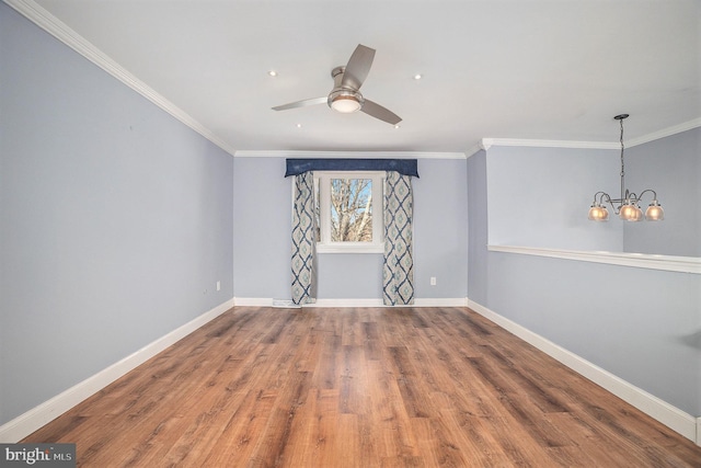 spare room featuring ceiling fan with notable chandelier, ornamental molding, and hardwood / wood-style floors