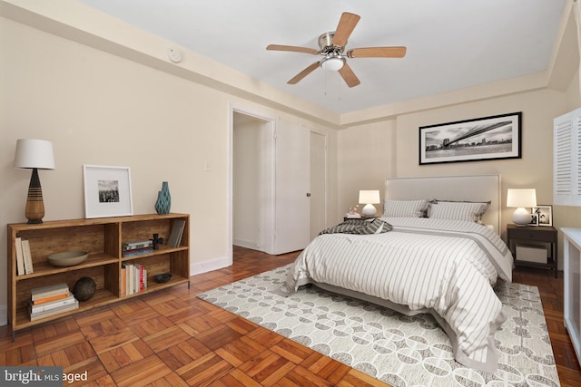 bedroom with ceiling fan and parquet floors