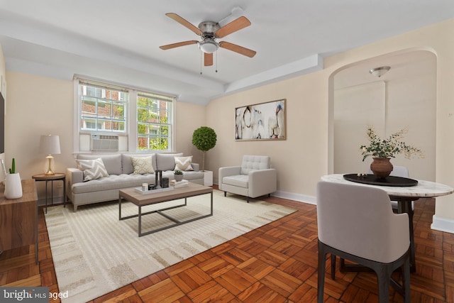 living room with dark parquet floors, ceiling fan, and cooling unit