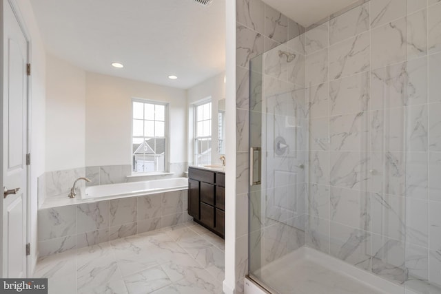 bathroom with vanity and separate shower and tub