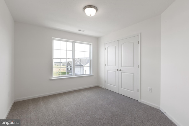 unfurnished bedroom featuring a closet and carpet floors