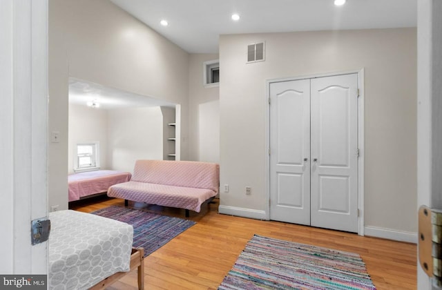 sitting room with lofted ceiling and light hardwood / wood-style flooring