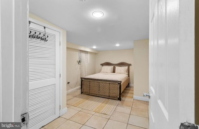 tiled bedroom with a closet