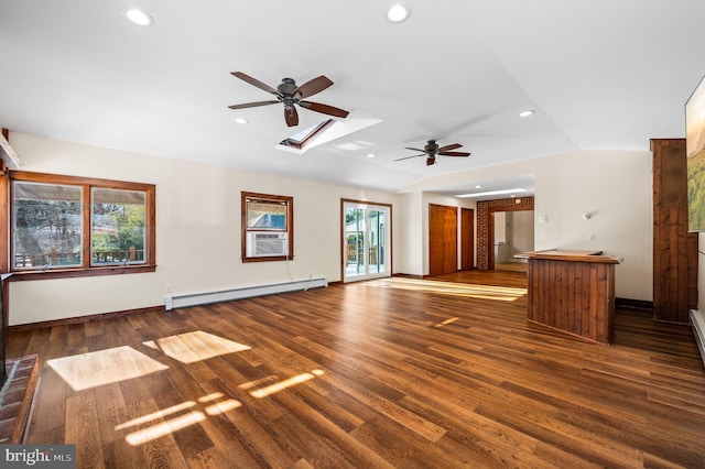 unfurnished living room with ceiling fan, dark hardwood / wood-style floors, a baseboard heating unit, cooling unit, and vaulted ceiling with skylight