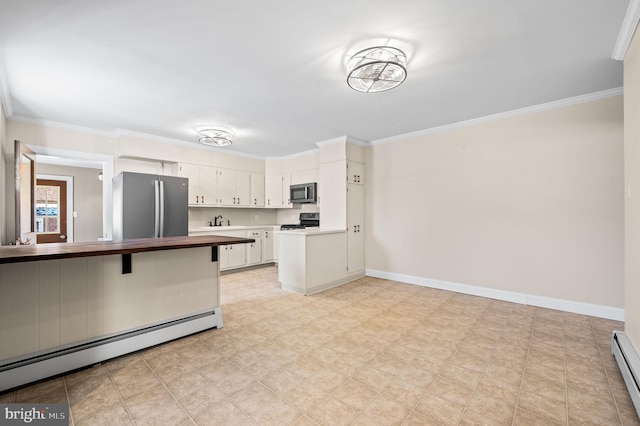 kitchen featuring white cabinets, crown molding, appliances with stainless steel finishes, and a baseboard radiator