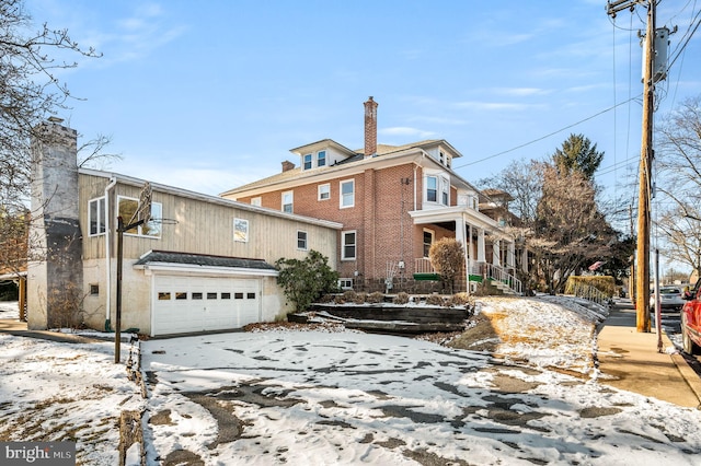 snow covered house with a garage