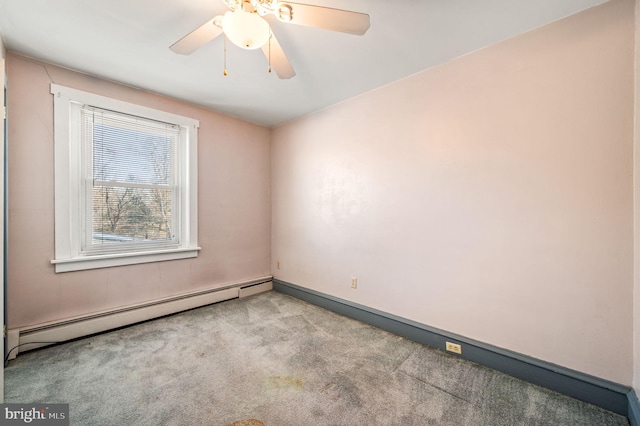 carpeted spare room featuring a baseboard radiator and ceiling fan