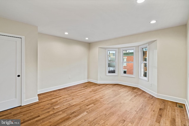 unfurnished room with light wood-type flooring