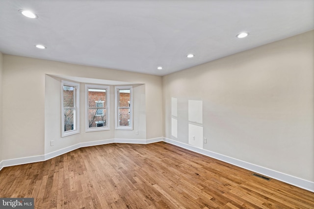 empty room with light hardwood / wood-style floors