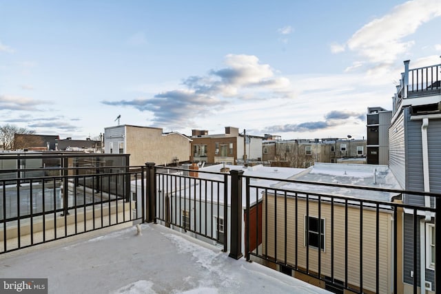 view of snow covered back of property