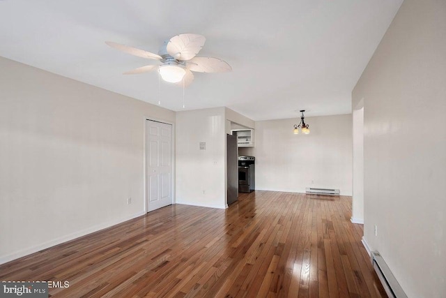 unfurnished living room with wood-type flooring, ceiling fan with notable chandelier, and a baseboard heating unit