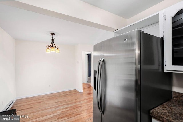 kitchen with decorative light fixtures, stainless steel fridge with ice dispenser, baseboard heating, and light hardwood / wood-style flooring