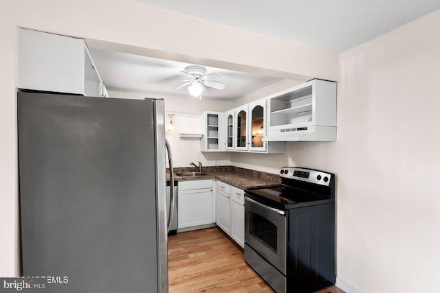 kitchen with white cabinetry, sink, ceiling fan, stainless steel appliances, and light hardwood / wood-style floors