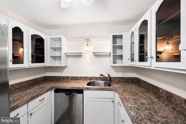 kitchen featuring dark stone countertops, sink, white cabinets, and stainless steel appliances