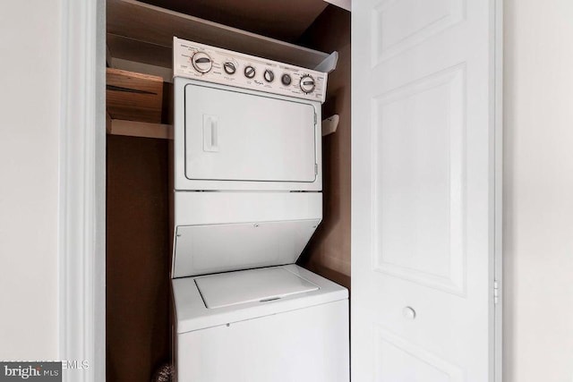 laundry room featuring stacked washer / dryer