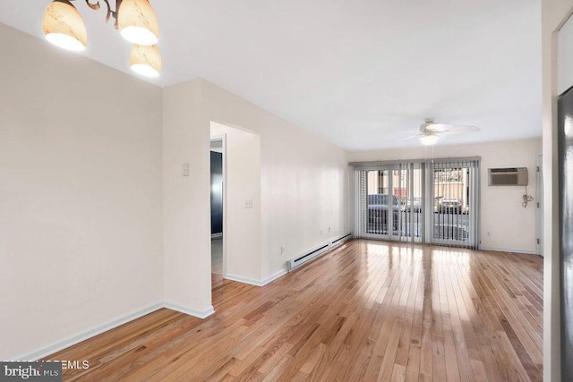 unfurnished living room with hardwood / wood-style floors, ceiling fan, an AC wall unit, and baseboard heating