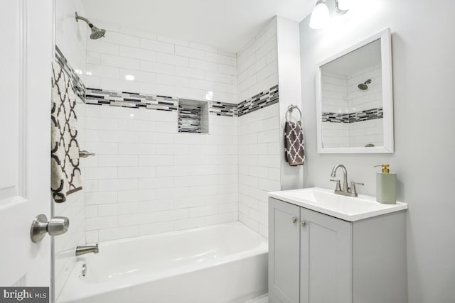 bathroom featuring vanity and tiled shower / bath