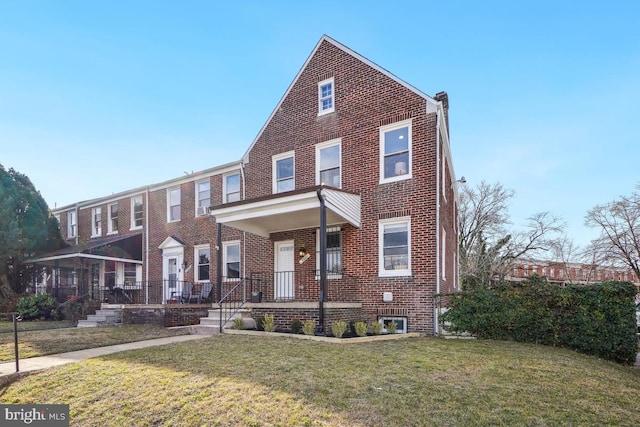 view of front of property with covered porch and a front yard