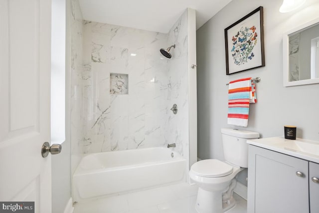 full bathroom with vanity, tiled shower / bath combo, and toilet