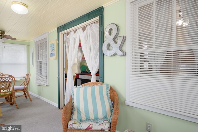 sitting room featuring carpet floors, ceiling fan, and wood ceiling