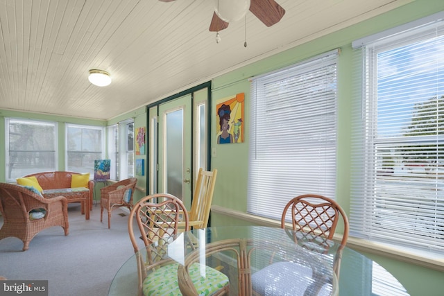 sunroom / solarium with ceiling fan and wood ceiling