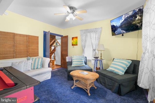 living room featuring carpet floors and ceiling fan