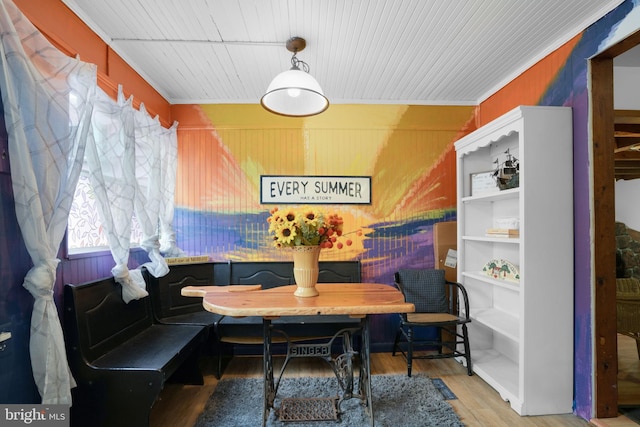 dining room with breakfast area, hardwood / wood-style flooring, and ornamental molding