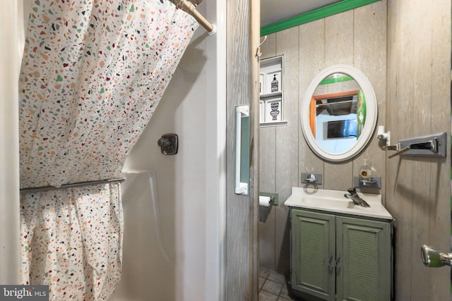 bathroom with vanity, curtained shower, and wooden walls