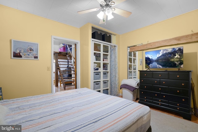 bedroom featuring ceiling fan and a closet