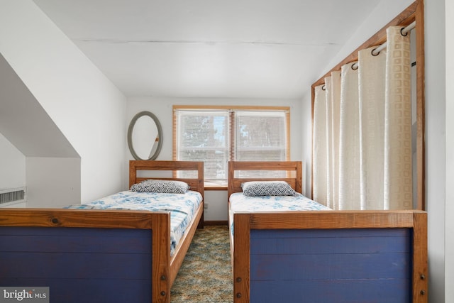 carpeted bedroom with lofted ceiling