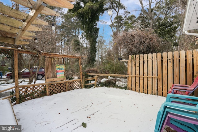 snow covered deck featuring a pergola